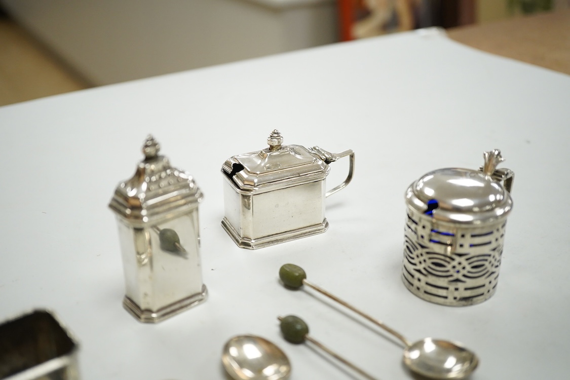 A George V silver three piece condiment set by Mappin & Webb, Birmingham, 1927(two lacking liners), together with one other silver mustard pot, four silver bean end coffee spoons and a white metal propelling pencil.